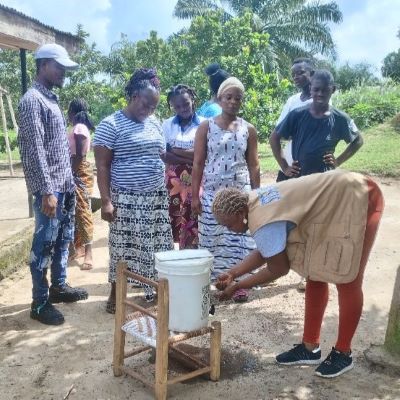 Villagers learning the right way of washing hands